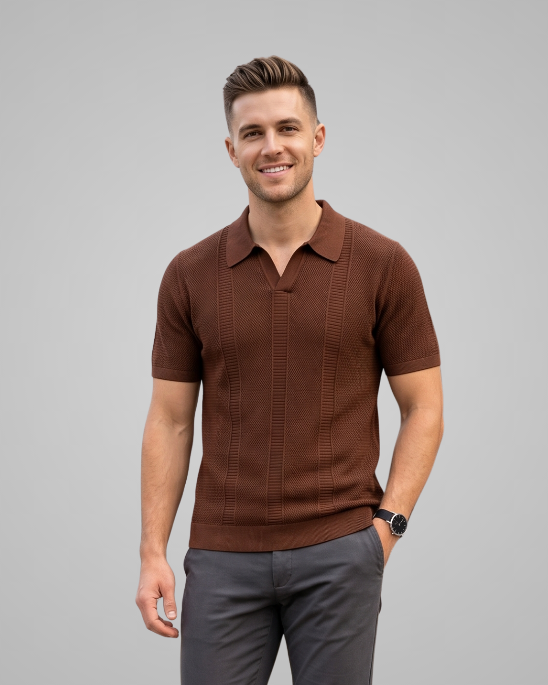 Man wearing a brown polo shirt and gray pants on a gray background