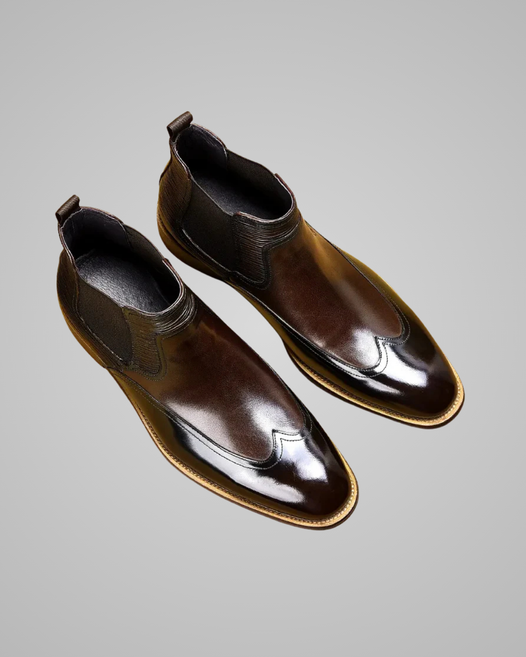 Pair of brown leather boots on a gray background