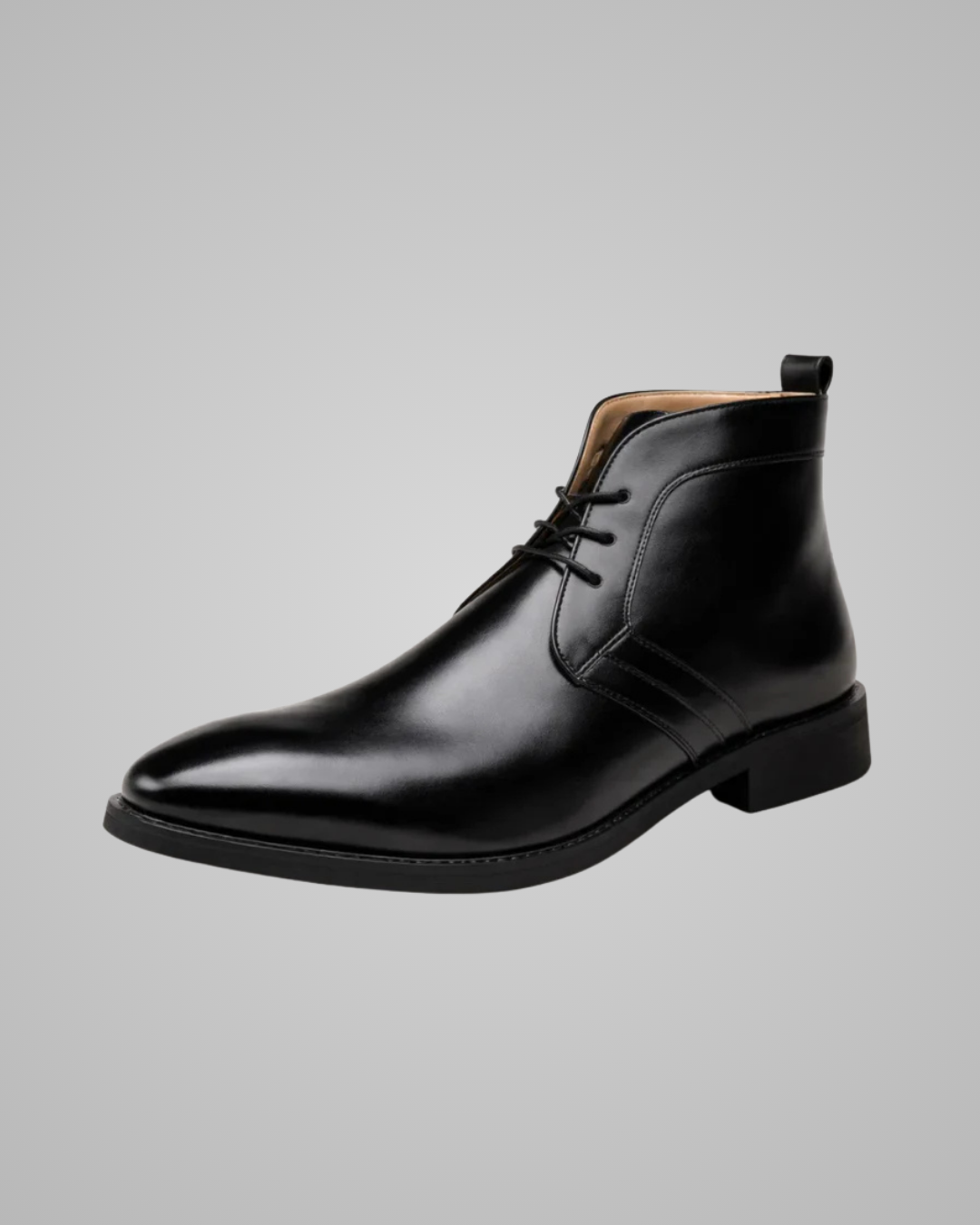 Black leather ankle boot on a gray background