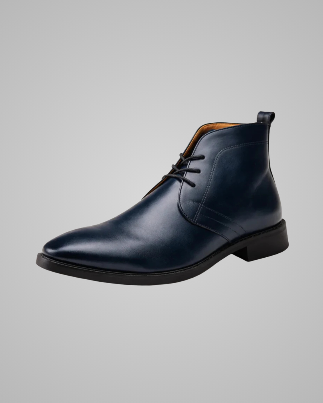 Blue leather chukka boot on a gray background