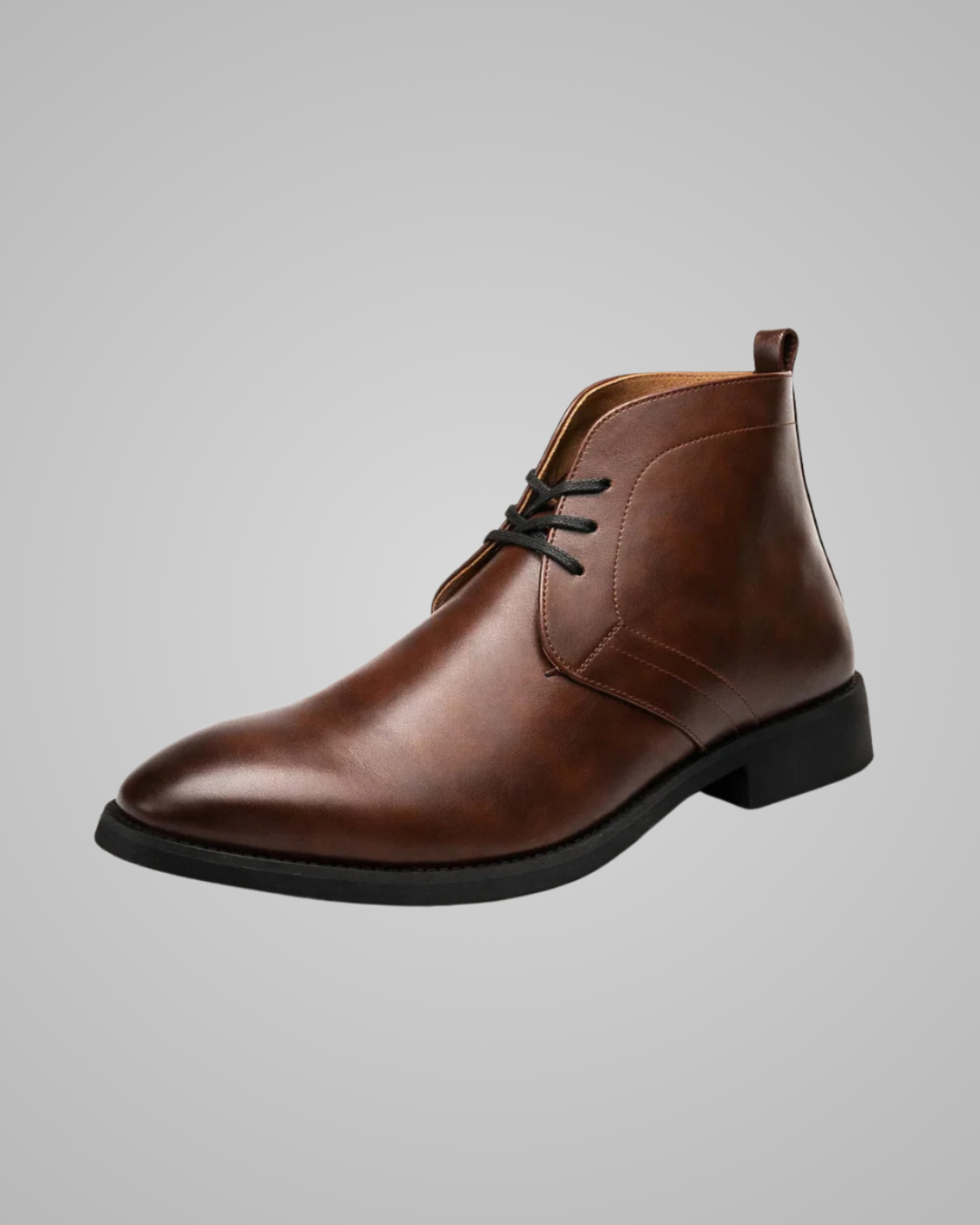 Brown leather chukka boot on a gray background