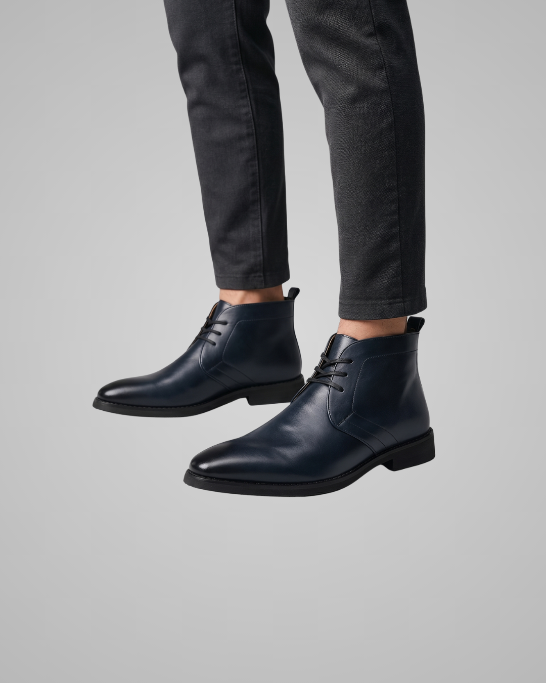 Blue leather ankle boot on a gray background