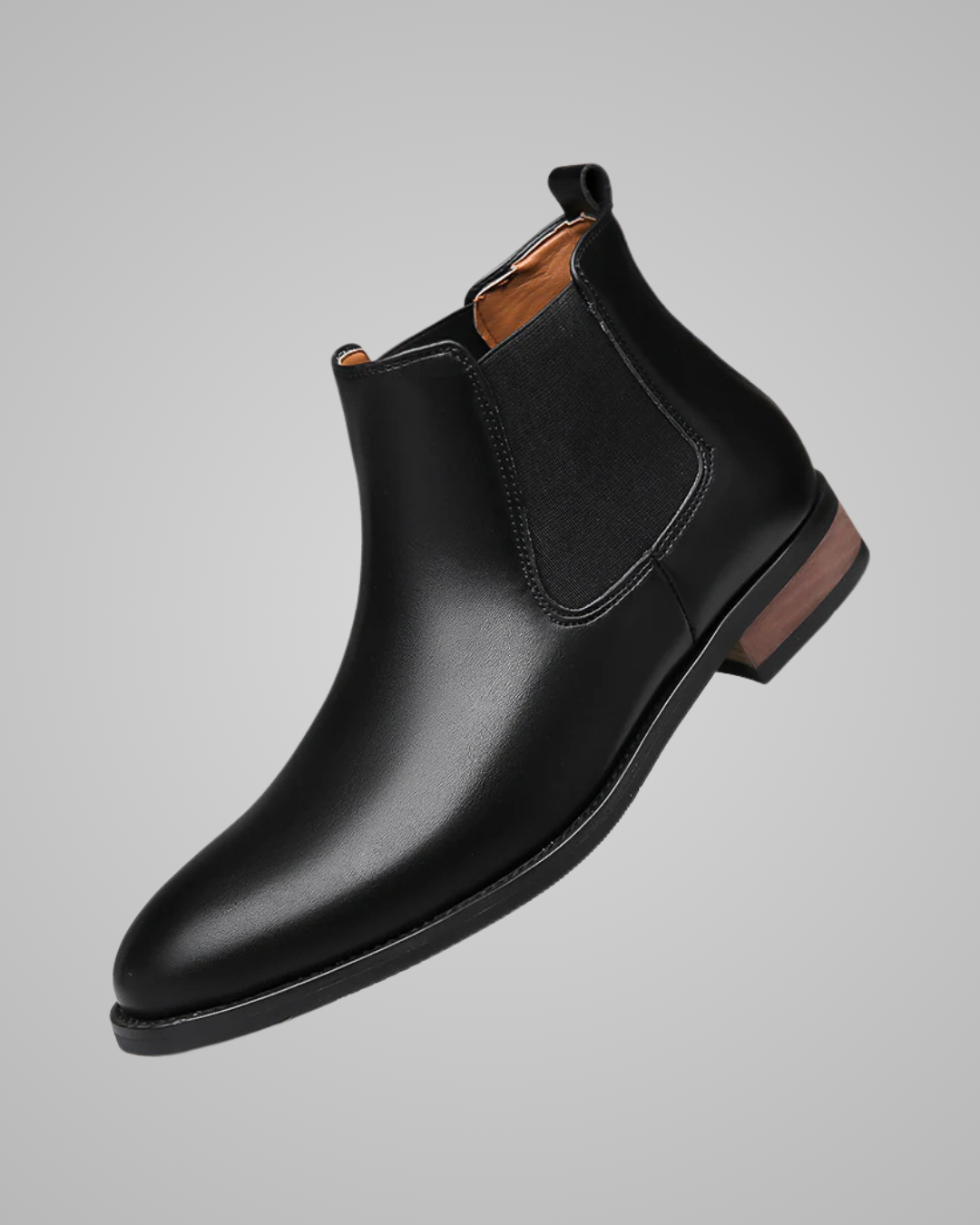 Black leather Chelsea boot on a gray background