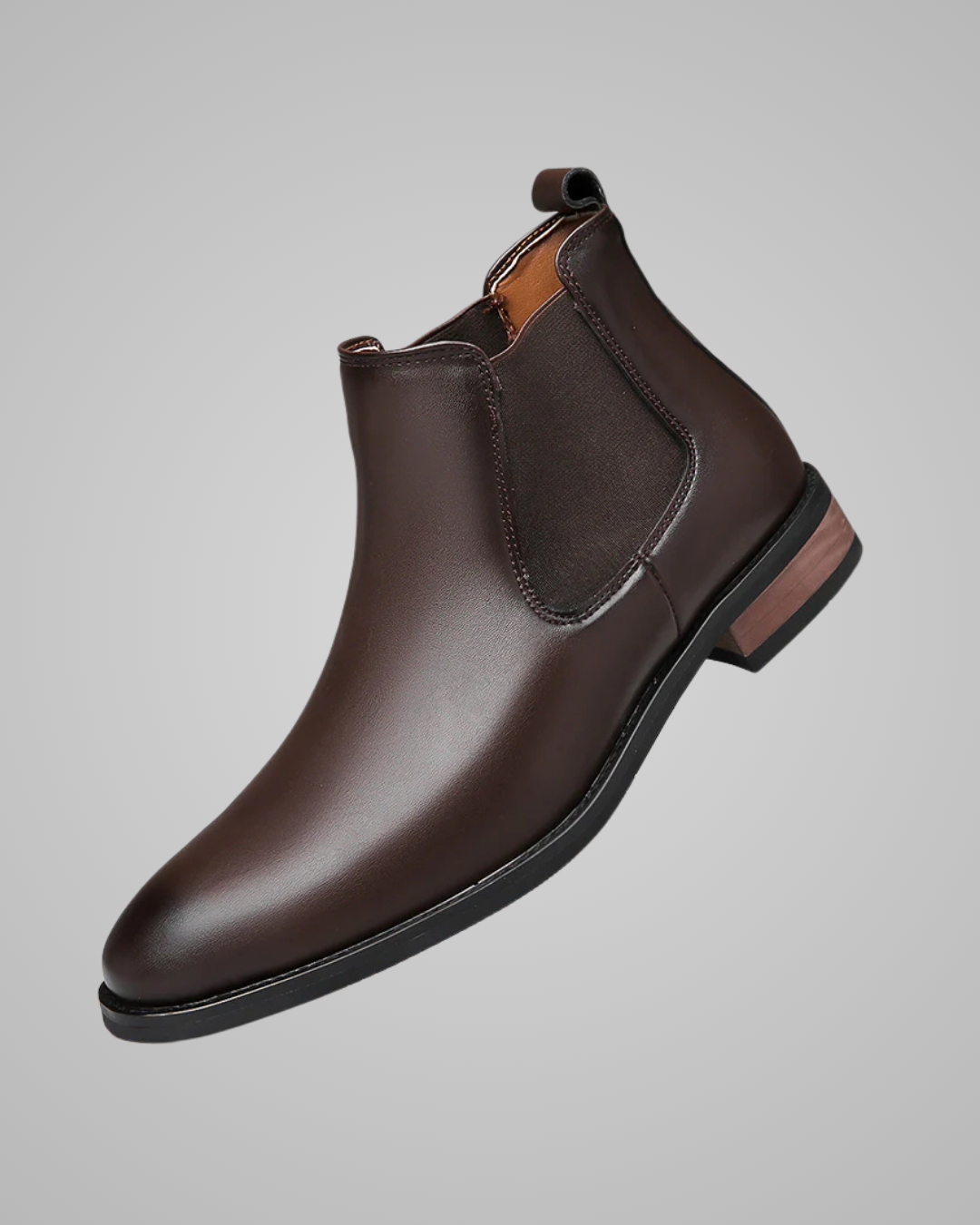 Brown leather Chelsea boot on a gray background