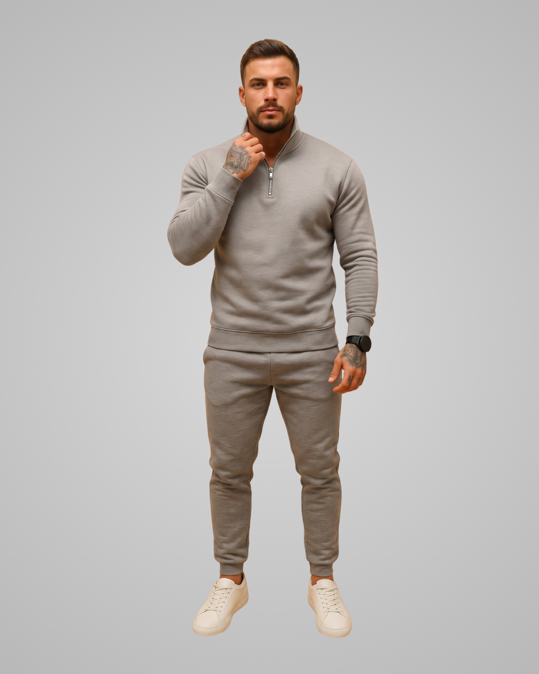 Man wearing a grey tracksuit on a gray background