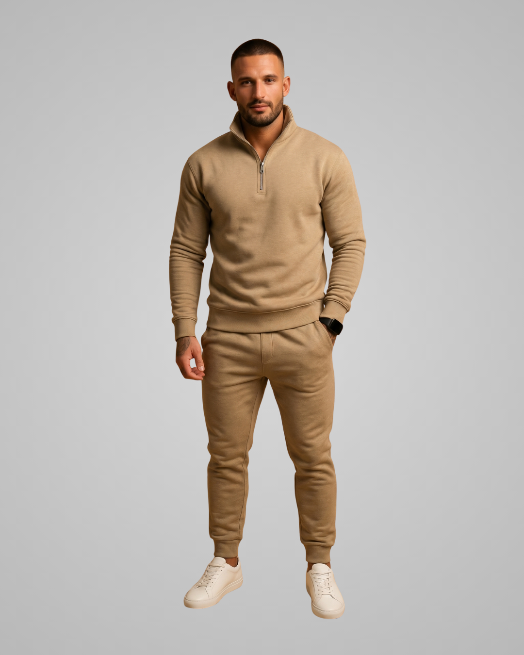 Man wearing a beige tracksuit on a gray background