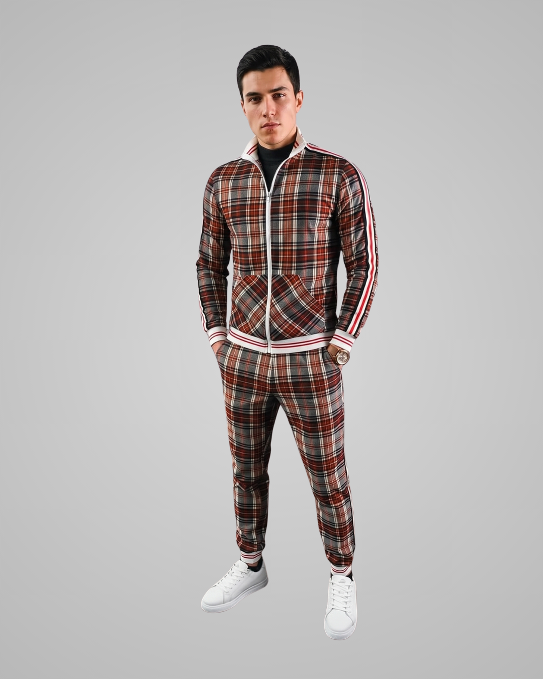 Man wearing a plaid tracksuit with white stripes on a gray background