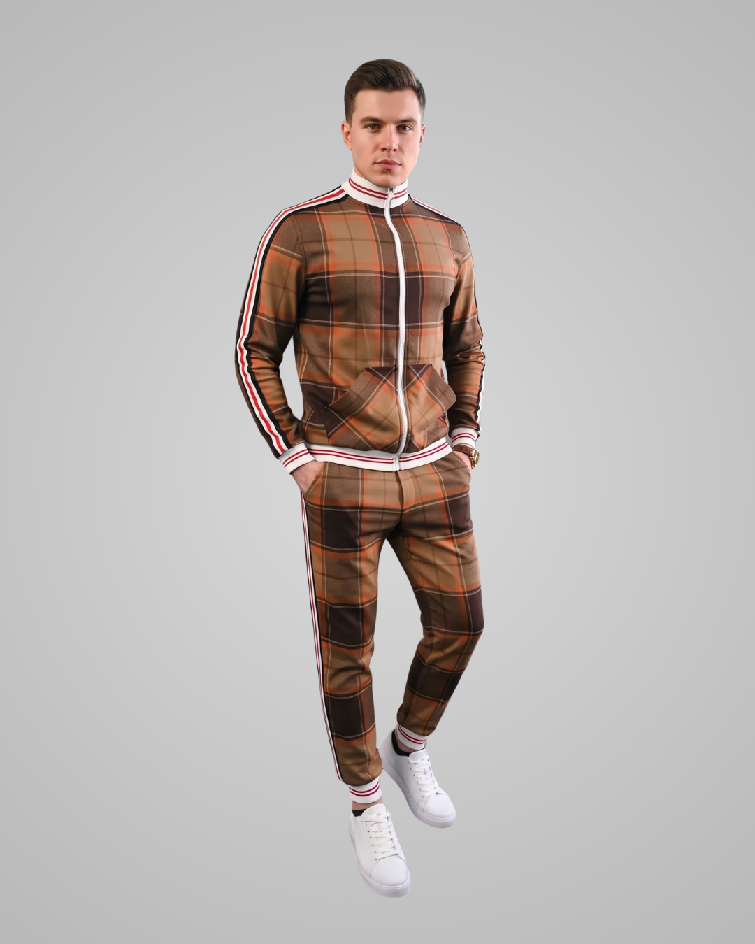 Man wearing a plaid tracksuit with white stripes on a gray background