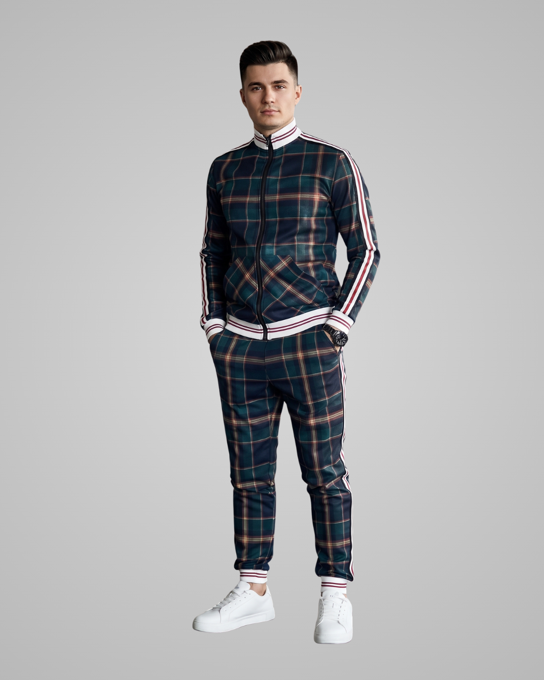 Man wearing a plaid tracksuit with white stripes on a gray background