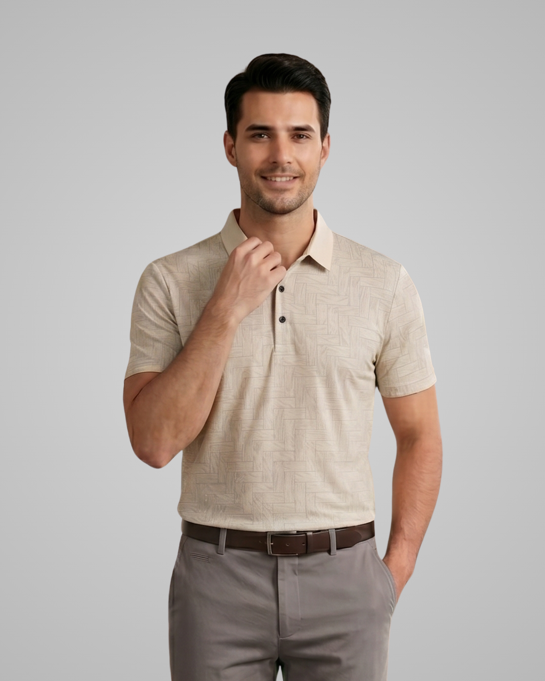 Man wearing a beige polo shirt and gray pants on a plain background