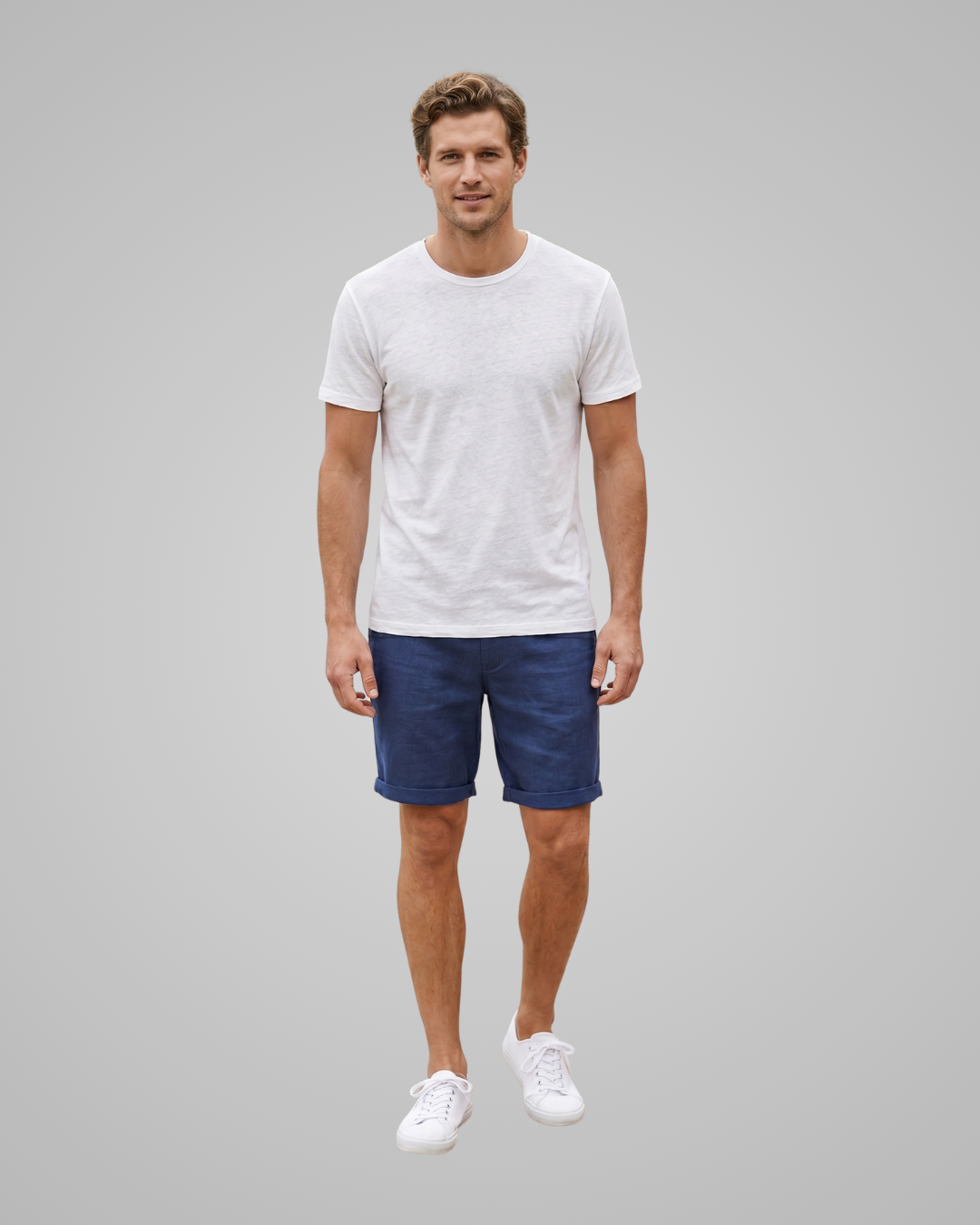 Man wearing a white t-shirt and blue shorts on a gray background