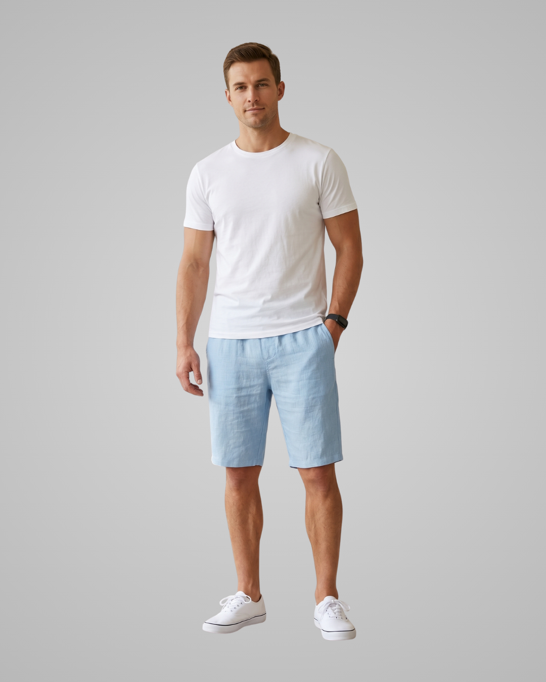 Man wearing a white t-shirt and light blue shorts on a gray background