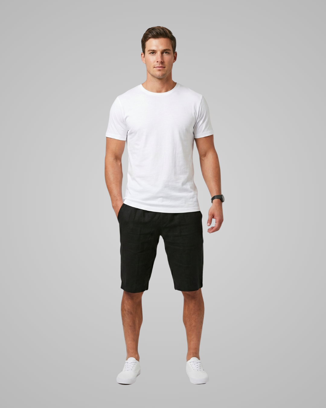 Man wearing a white t-shirt and black shorts on a gray background