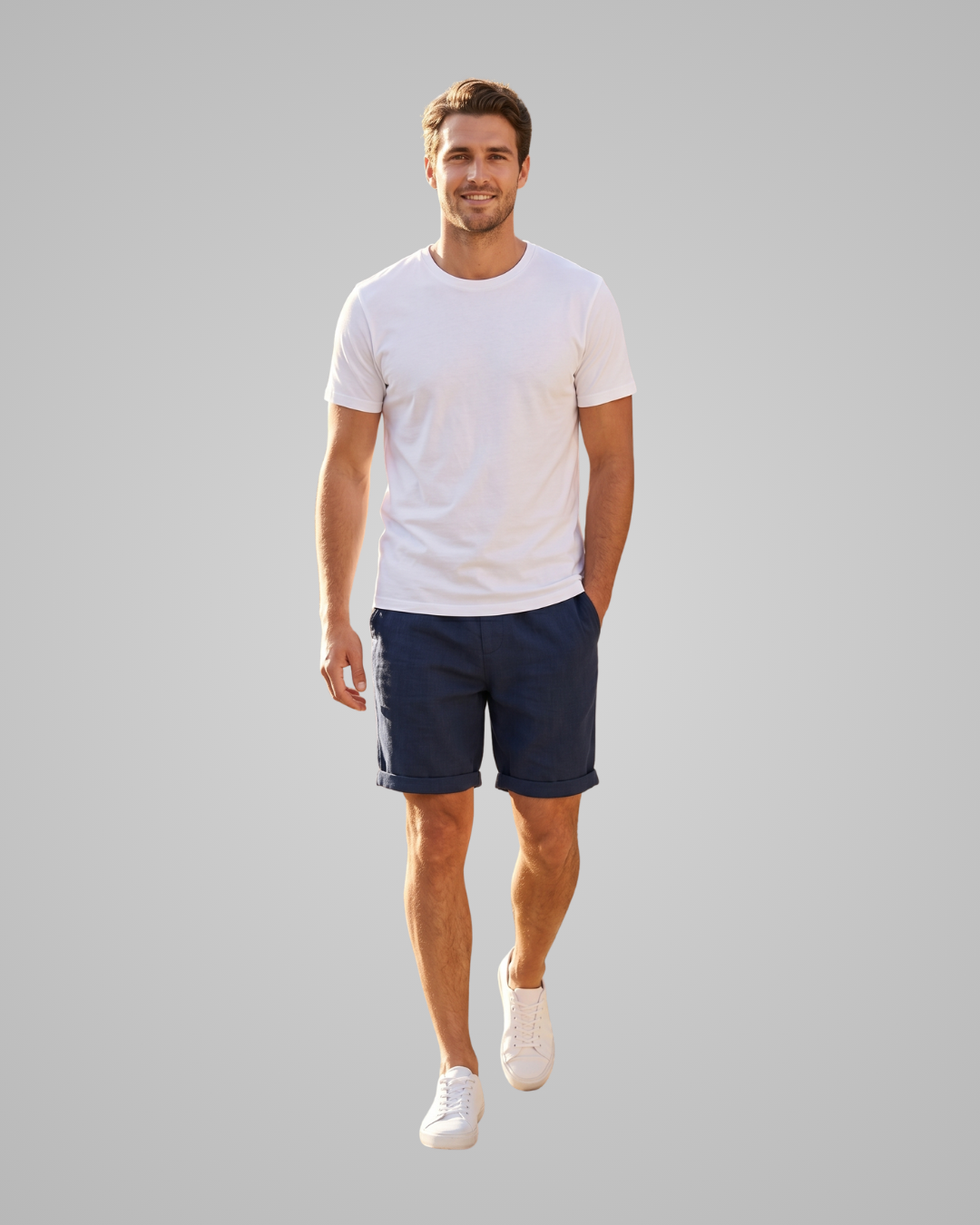 Man wearing a white t-shirt and navy shorts on a gray background