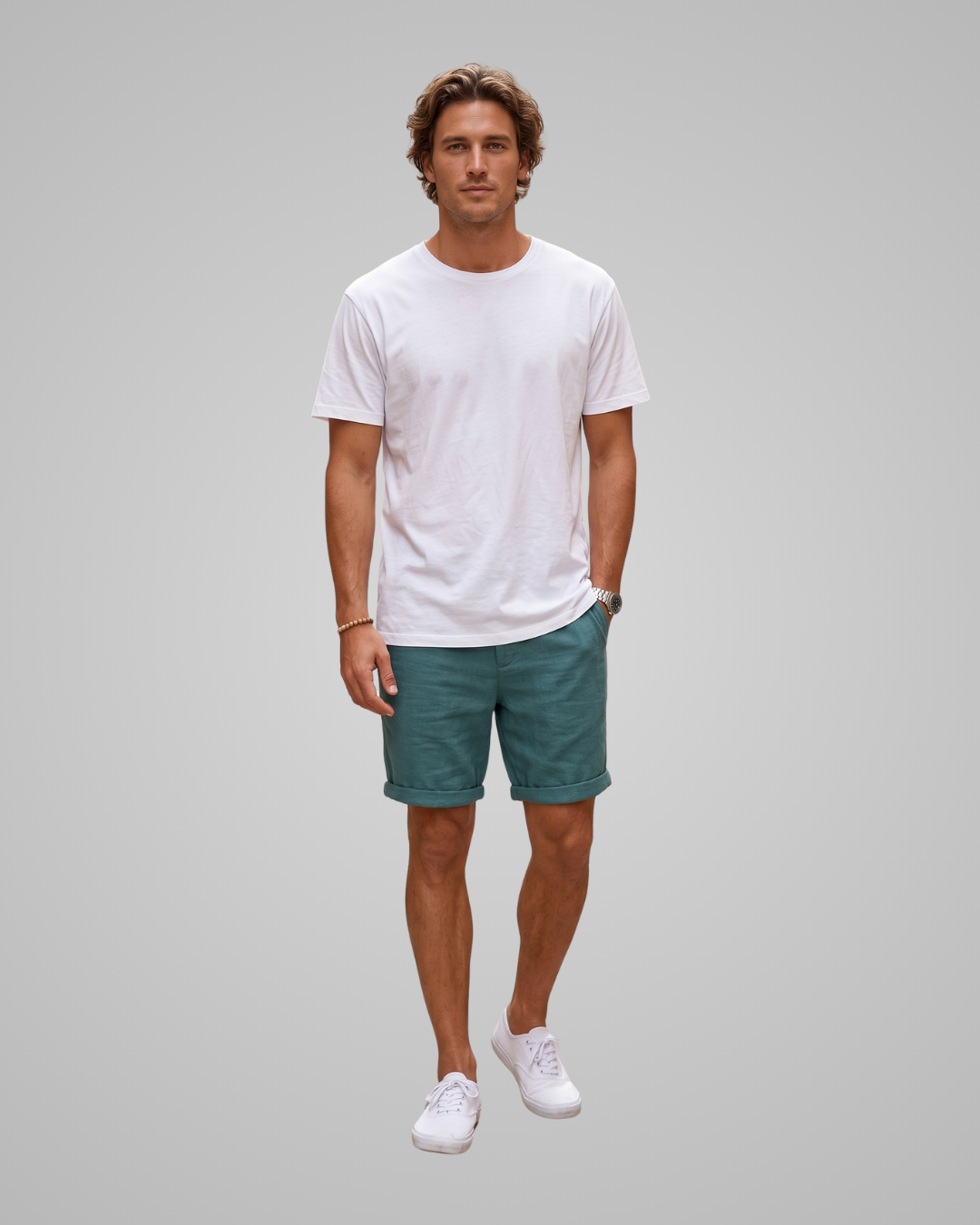 Man wearing a white t-shirt and green shorts on a gray background