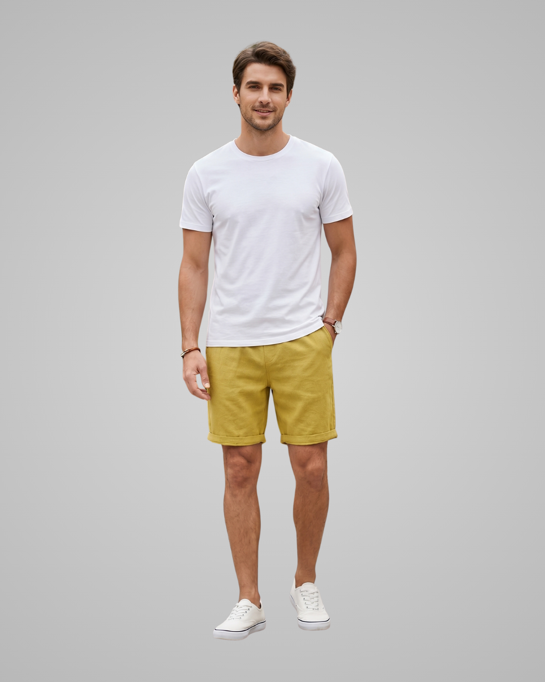 Man wearing a white t-shirt and yellow shorts on a gray background