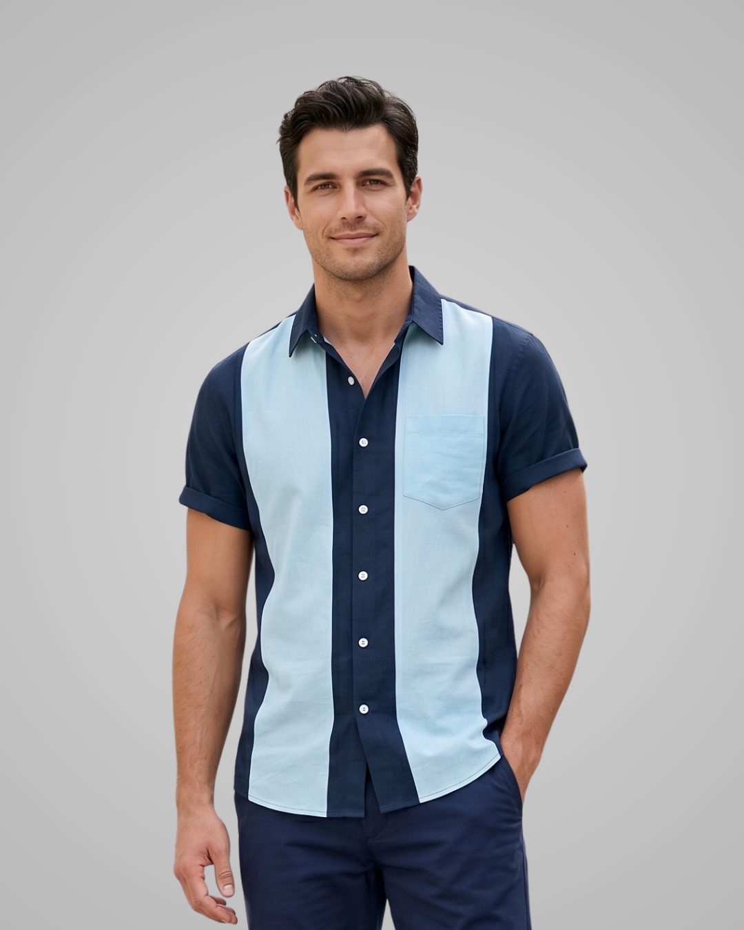 Man wearing a blue and light blue striped shirt against a gray background