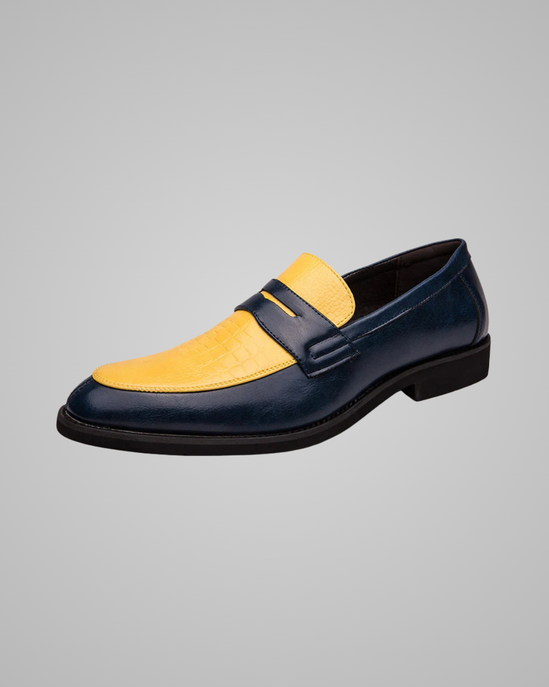 Navy and yellow loafer shoe on a gray background