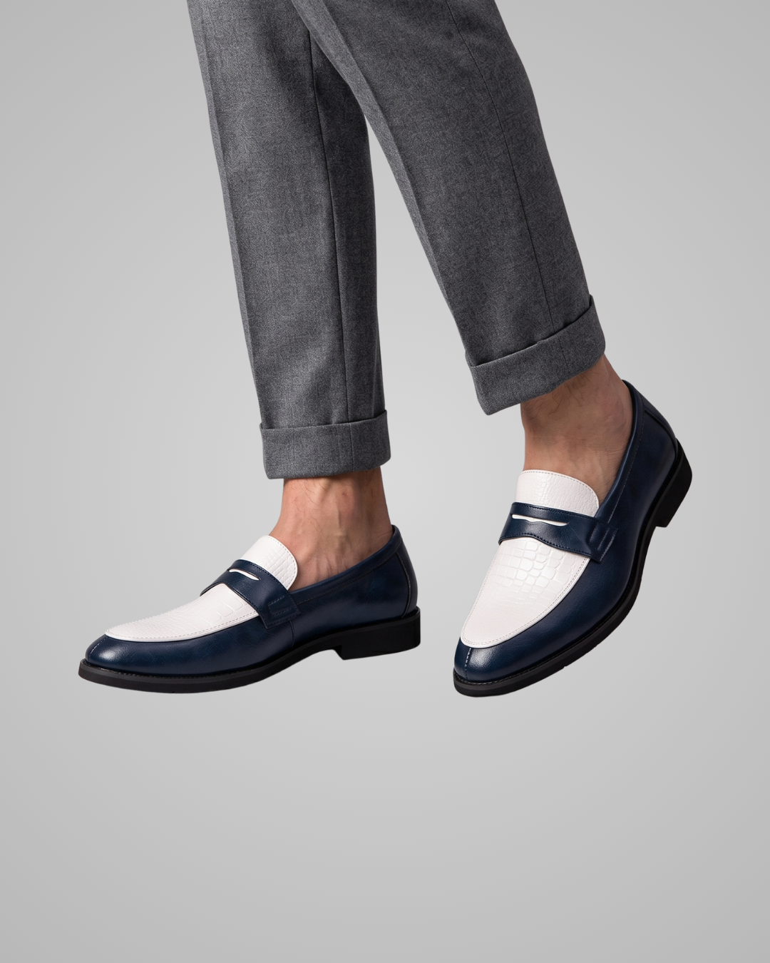 Navy and white loafer shoe on a gray background