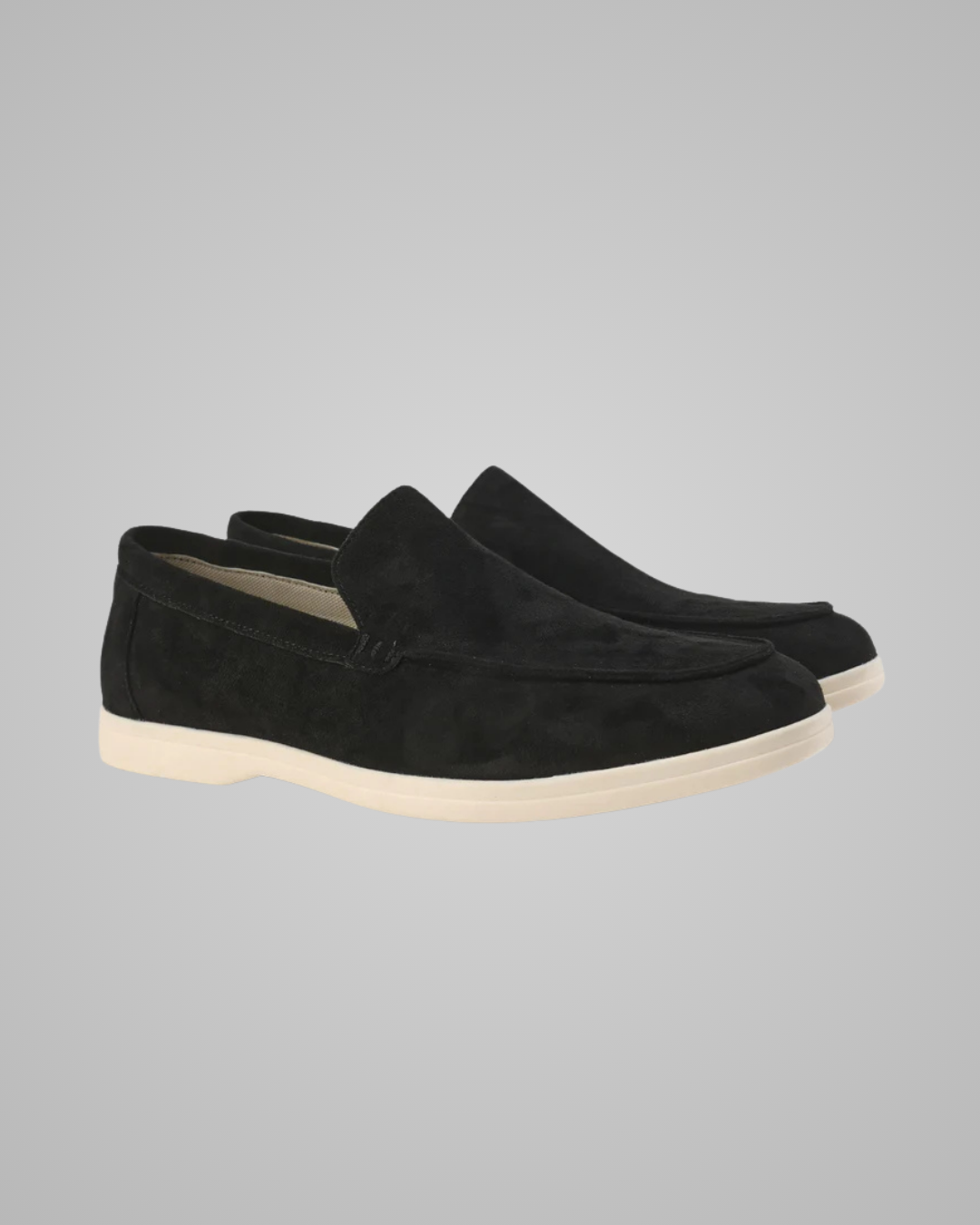Pair of black suede loafers on a white background