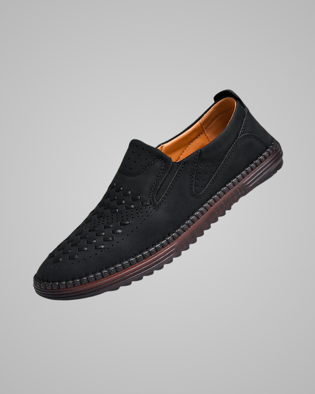 Black leather shoe on a gray background