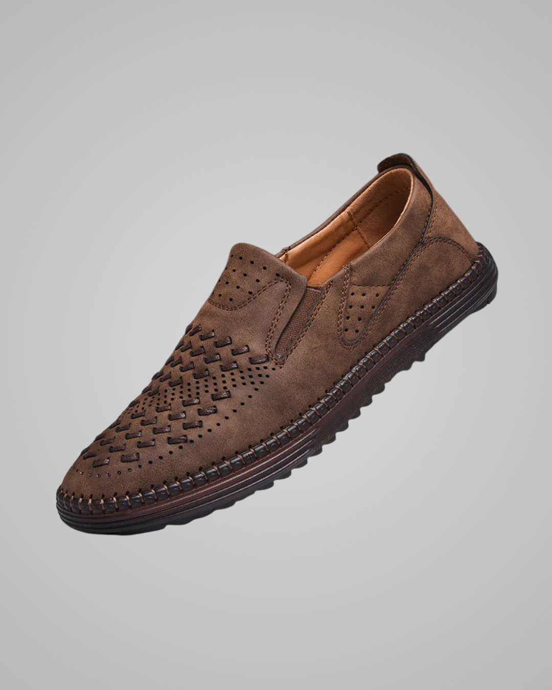Brown leather loafer shoe on a gray background