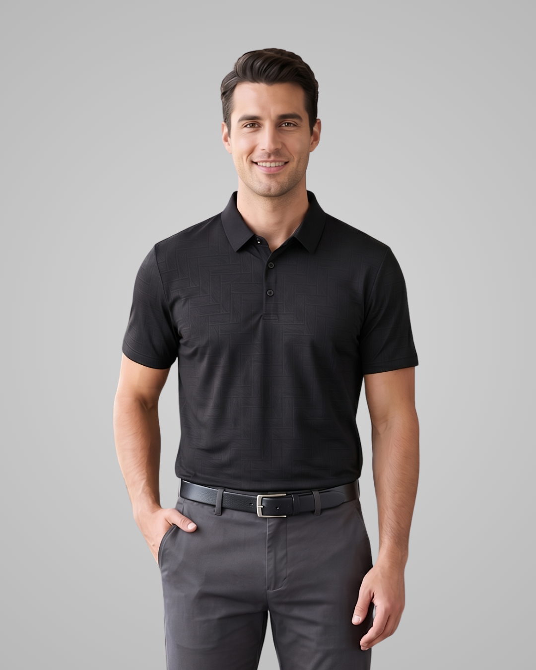 Man wearing a black polo shirt and gray pants against a gray background