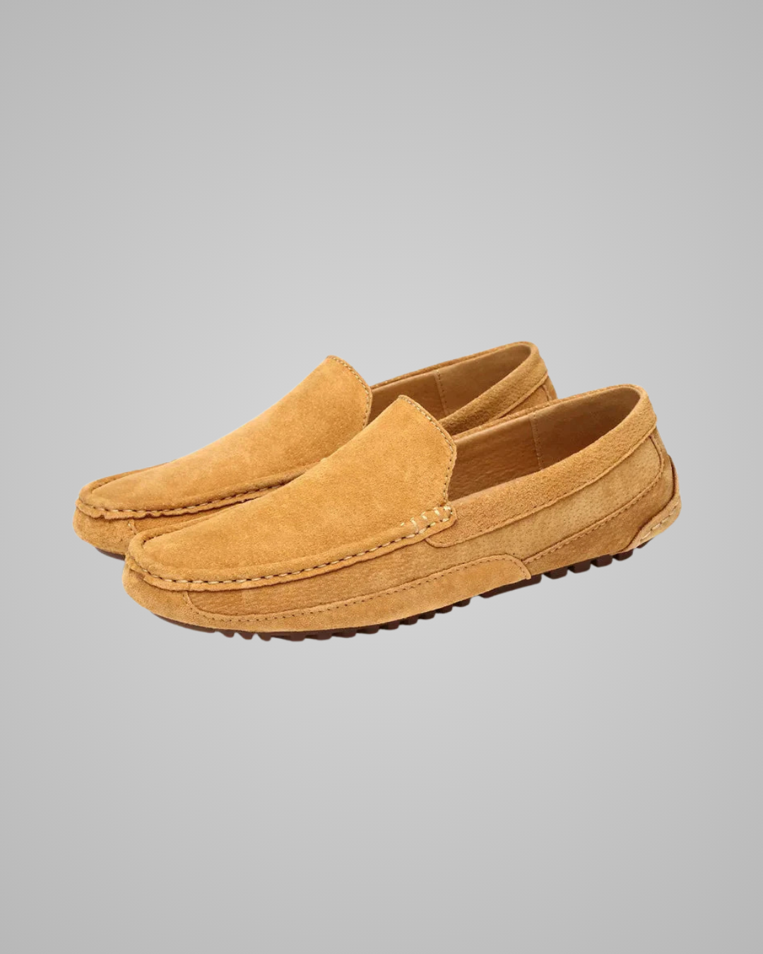 Pair of tan loafers on a gray background