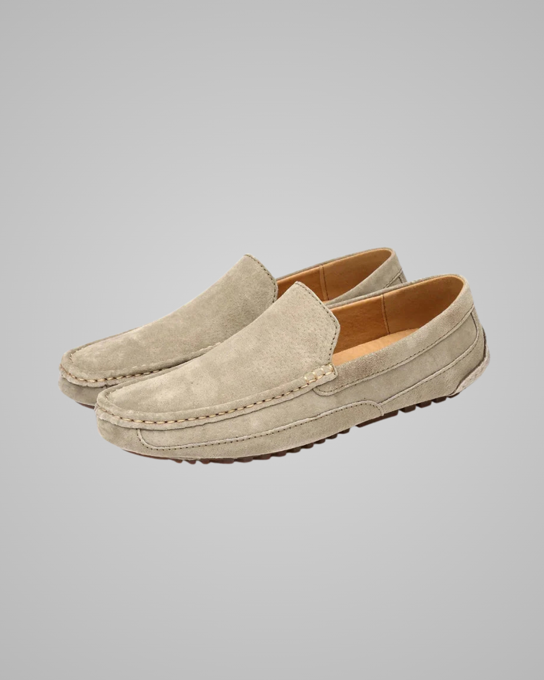 Pair of beige loafers on a gray background