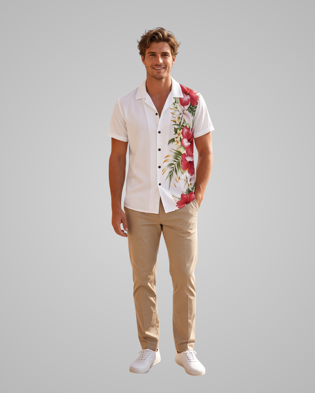 A man modeling a white short-sleeve button-up shirt with a vibrant red and green tropical floral print on the right side, paired with khaki pants and white sneakers, against a solid gray background.