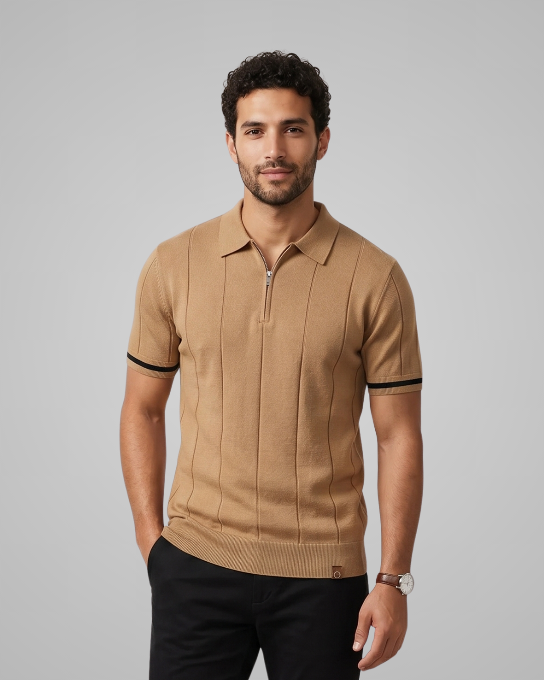 Man wearing a beige polo shirt with black trim on a gray background