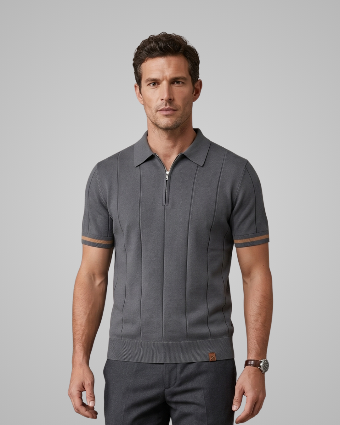 Man wearing a gray polo shirt with a zipper on a gray background
