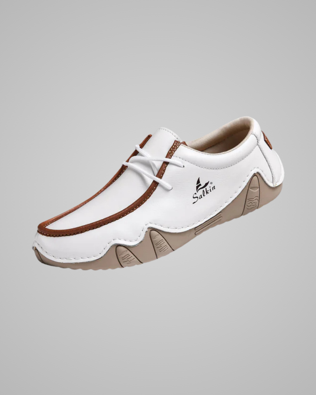 White and brown shoe with 'Sukhin' branding on a gray background