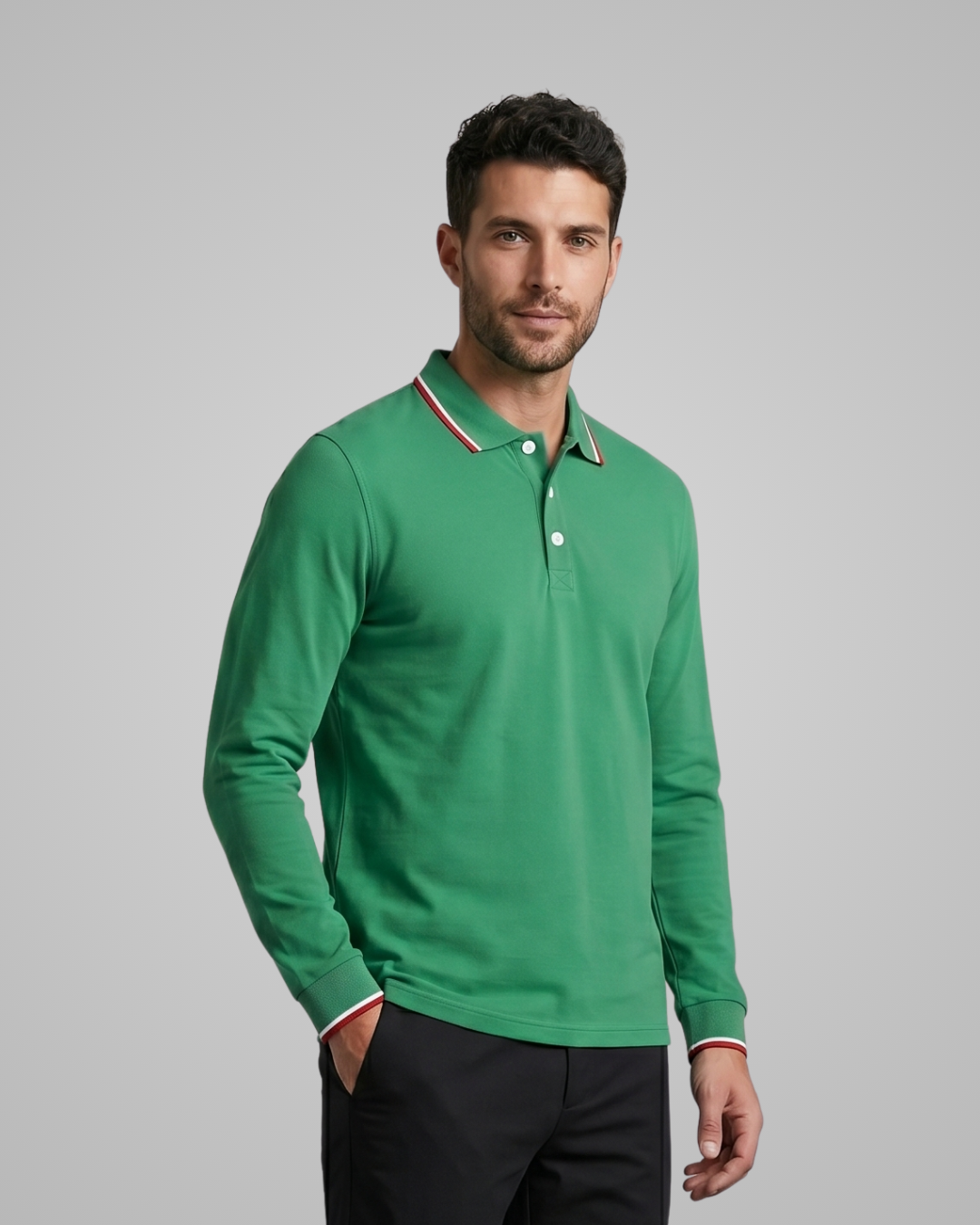 Man wearing a green long-sleeve polo shirt with a gray background