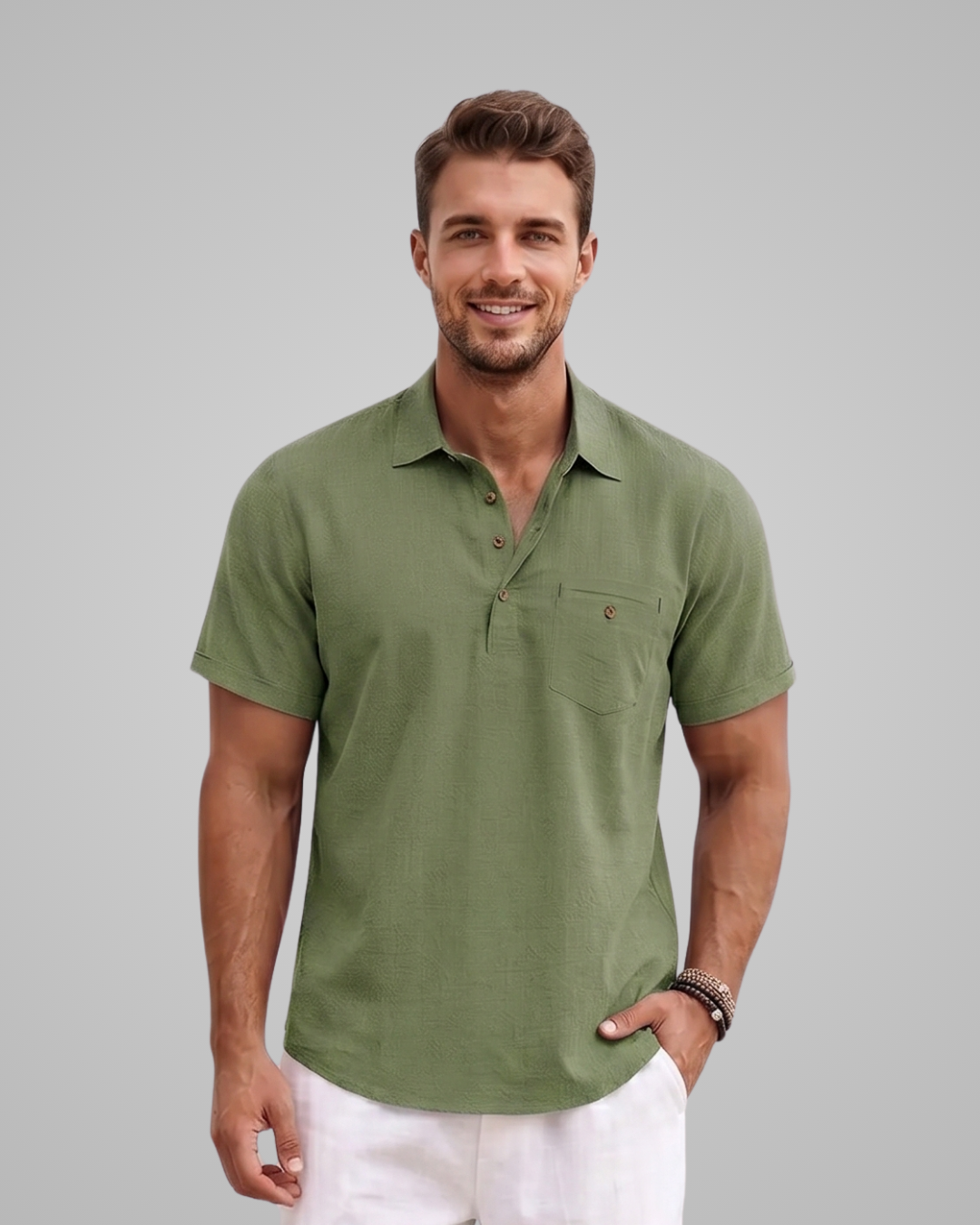 Man wearing a green polo shirt against a gray background