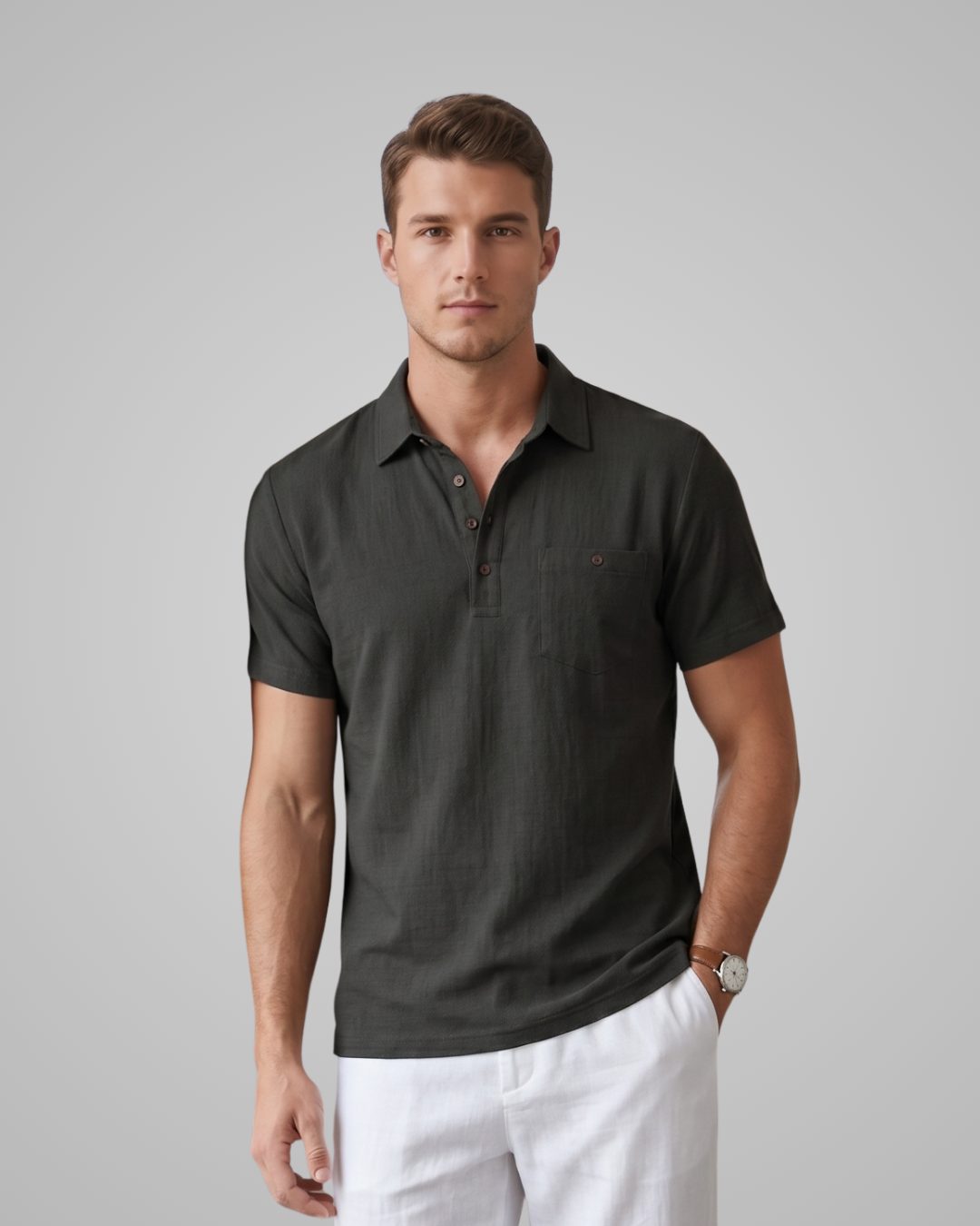 Man wearing a dark green polo shirt and white pants on a gray background