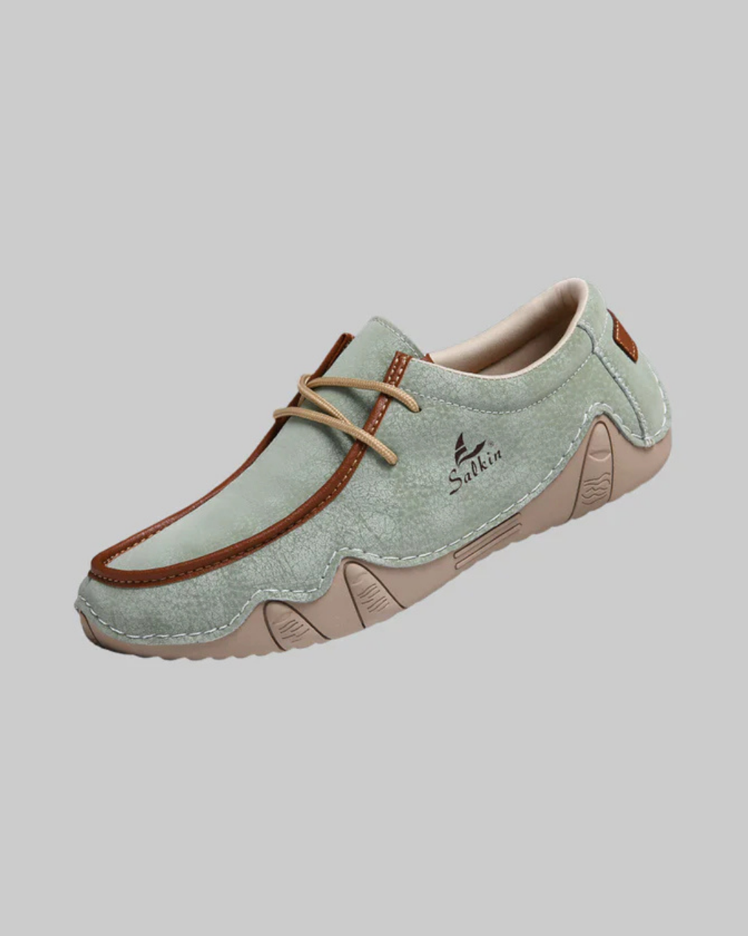 Light blue shoe with brown accents on a gray background