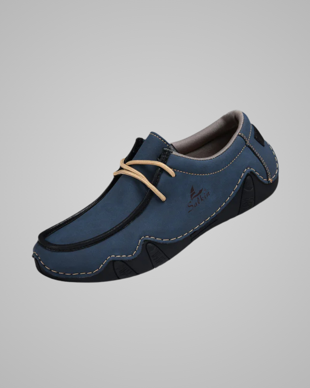 Blue loafer shoe on a gray background