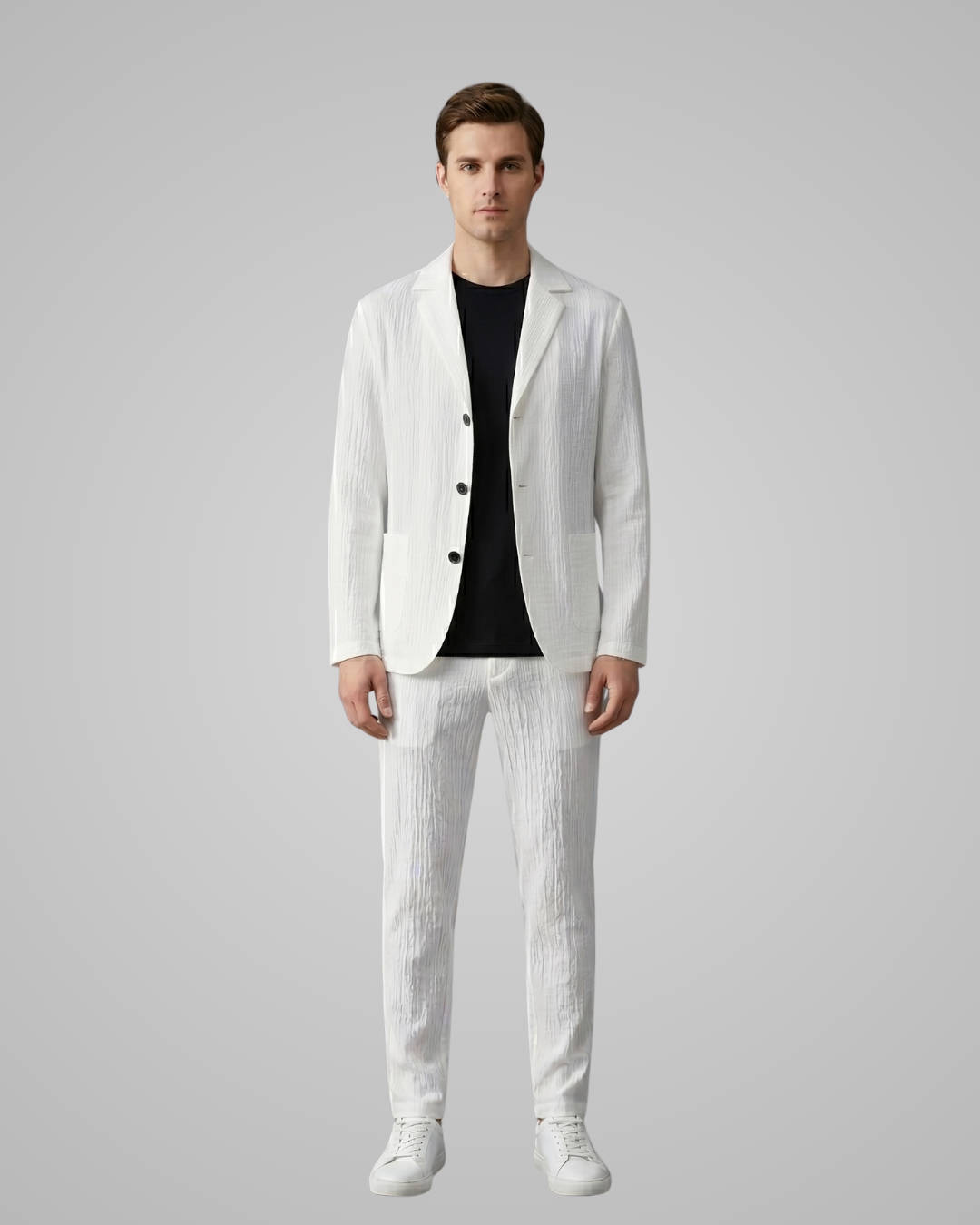 Man wearing a white suit with black shirt on a gray background