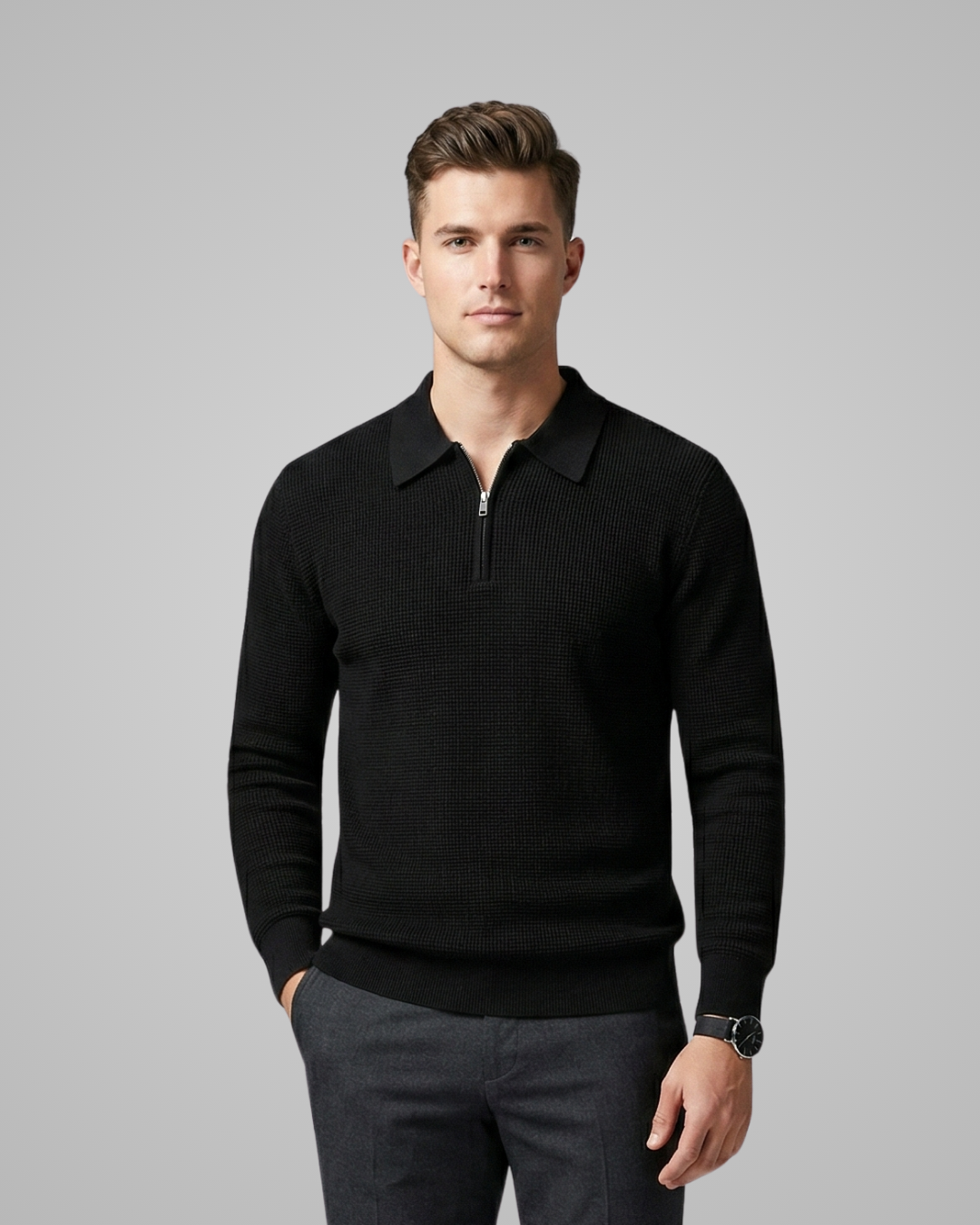 Man wearing a black sweater with a collar on a gray background