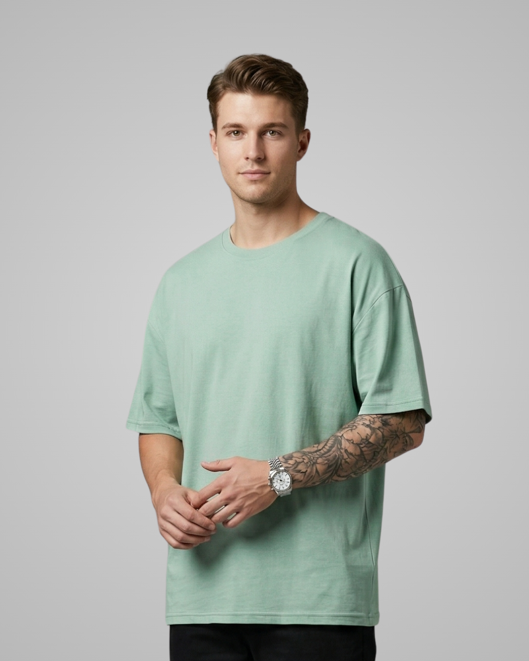 Man wearing a light green t-shirt against a plain background