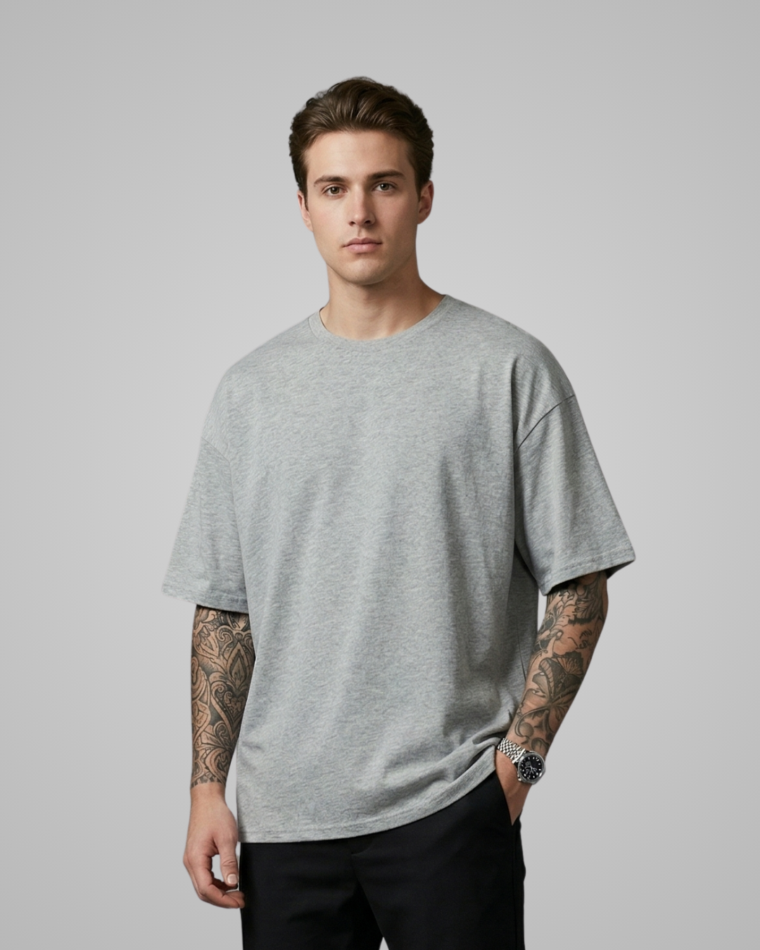 Man wearing a gray t-shirt against a plain background