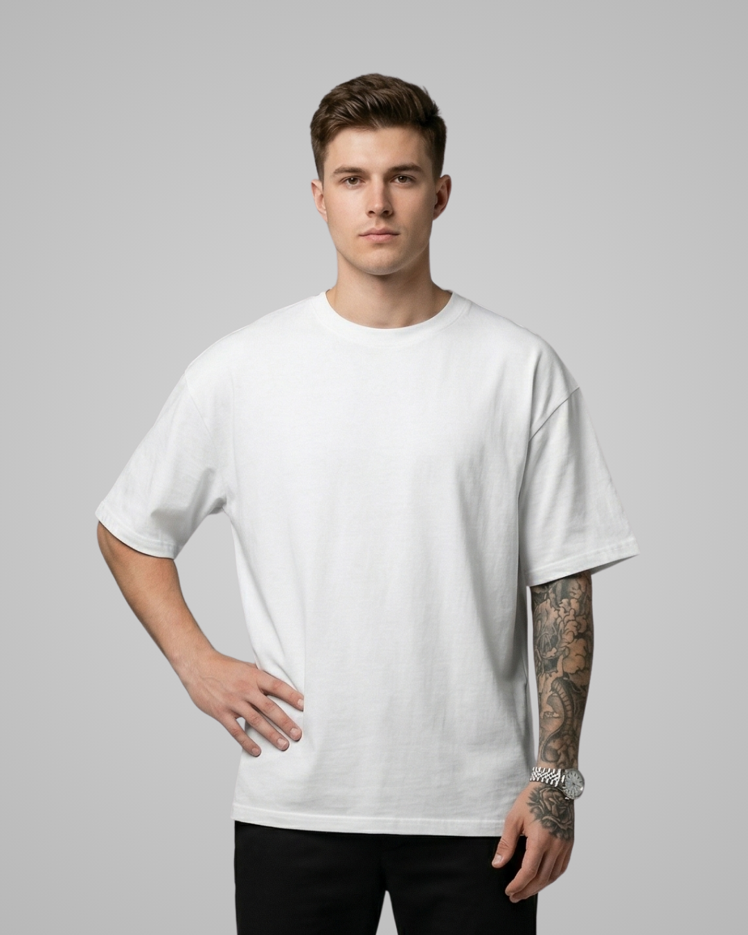 Man wearing a plain white t-shirt against a gray background