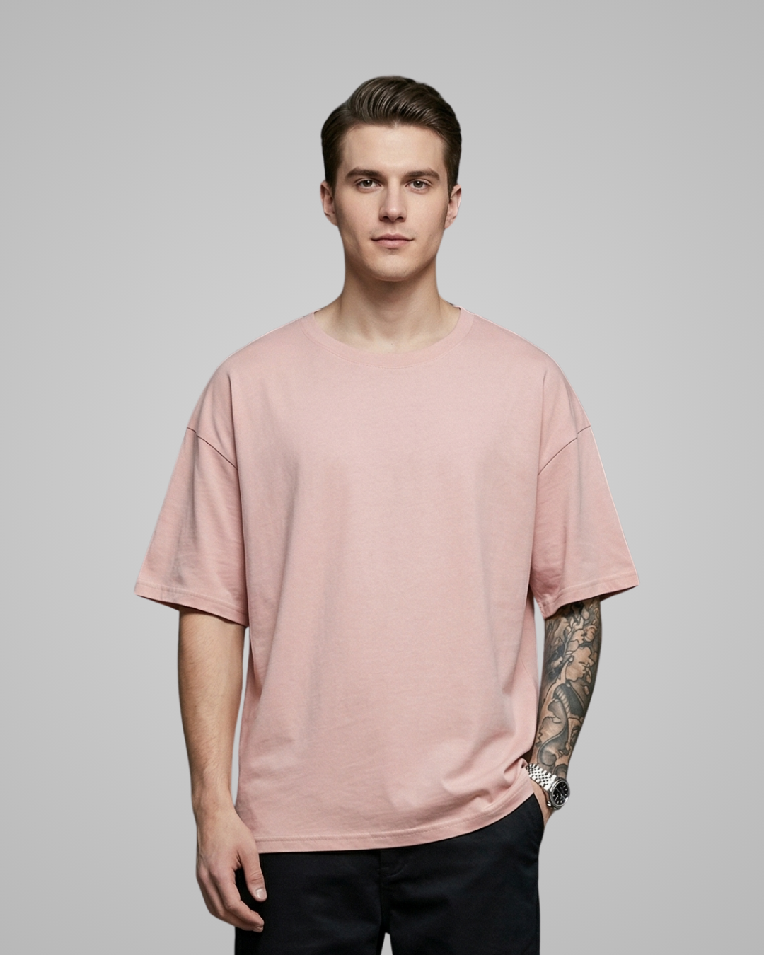 Man wearing a pink t-shirt against a gray background