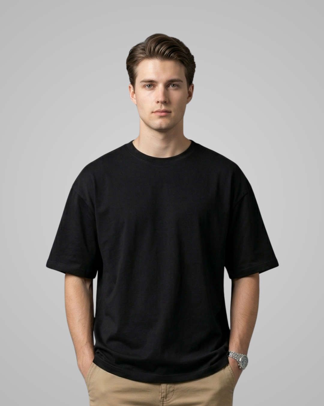 Man wearing a black t-shirt against a gray background