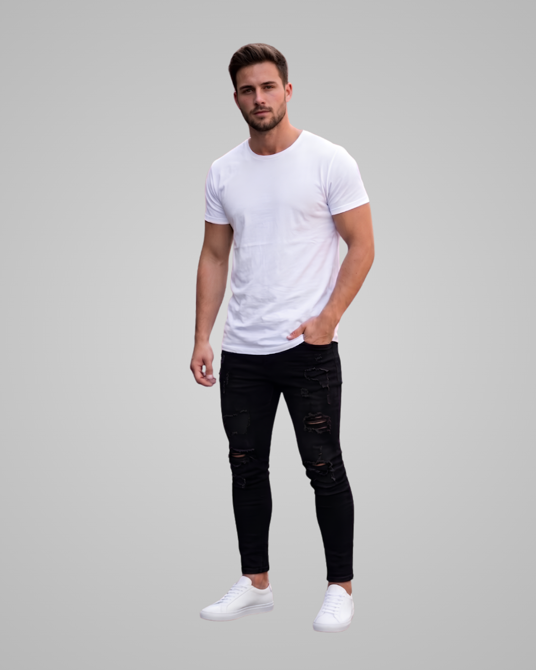 A man modeling a white crew-neck t-shirt paired with black distressed skinny jeans and white sneakers, set against a solid light gray background.