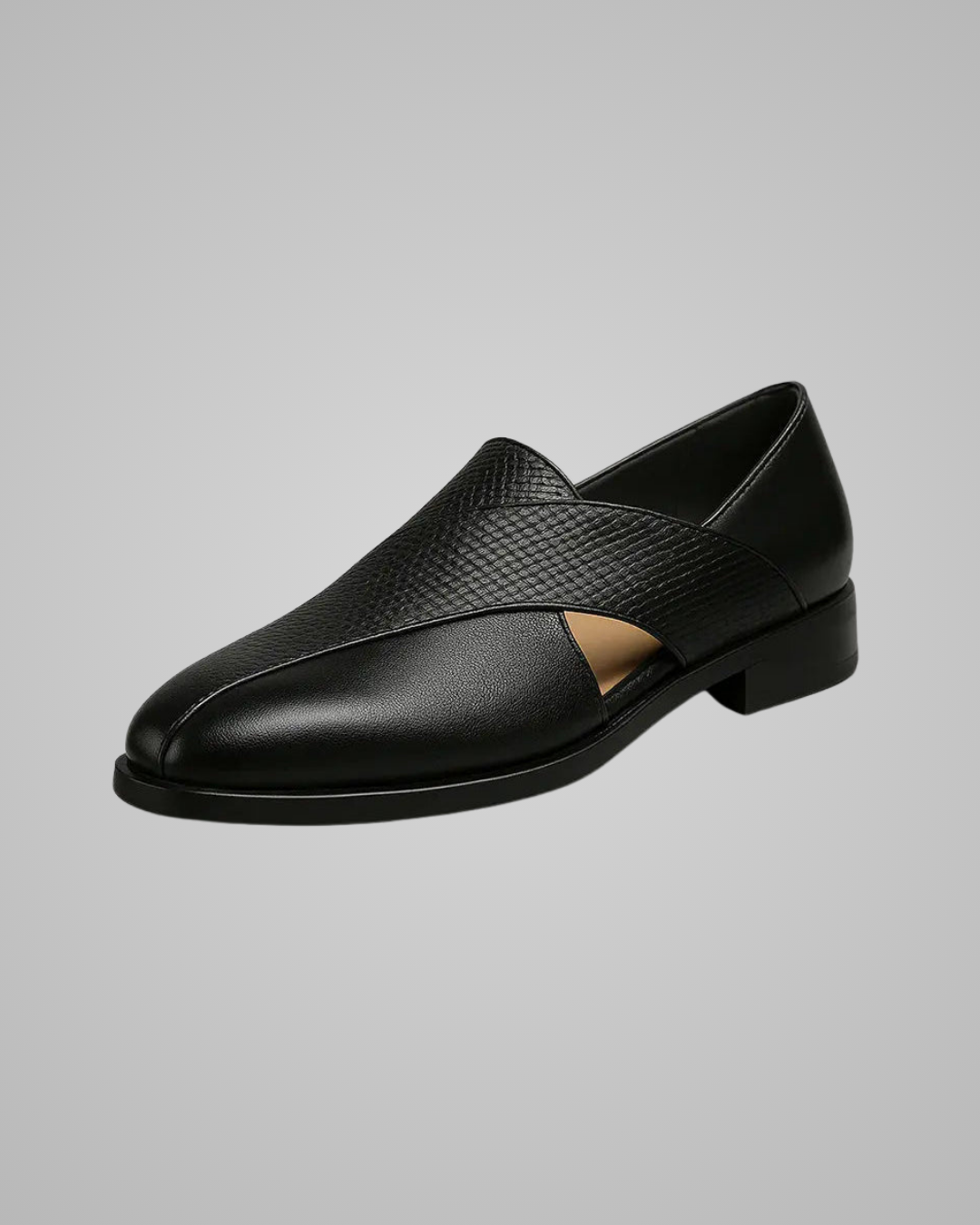 Black leather loafer shoe on a gray background