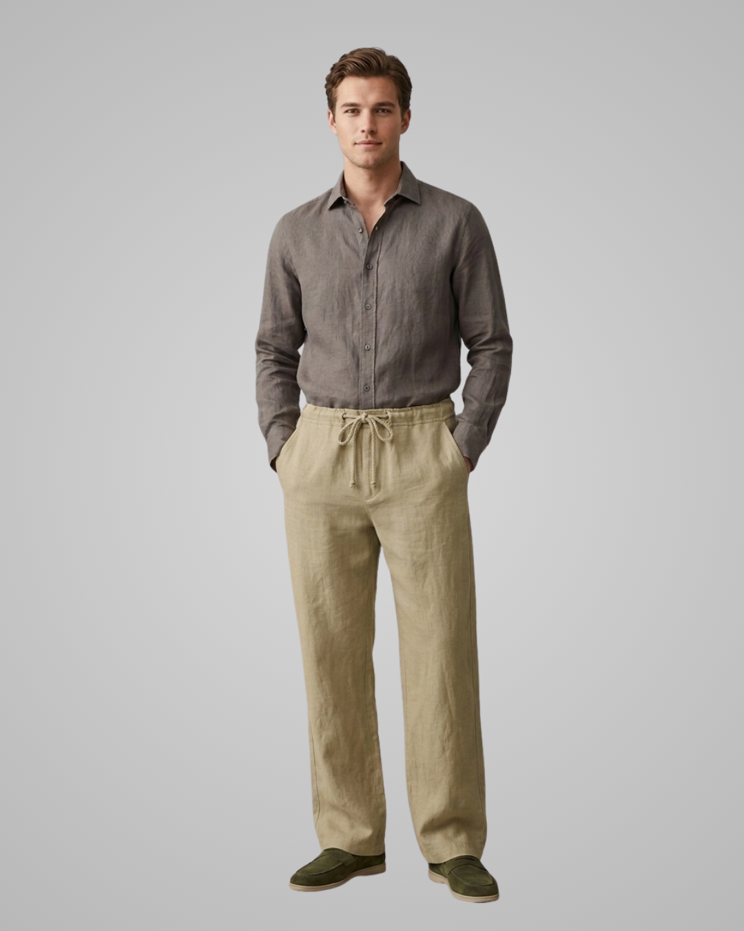 Man wearing a gray shirt and beige pants on a plain background
