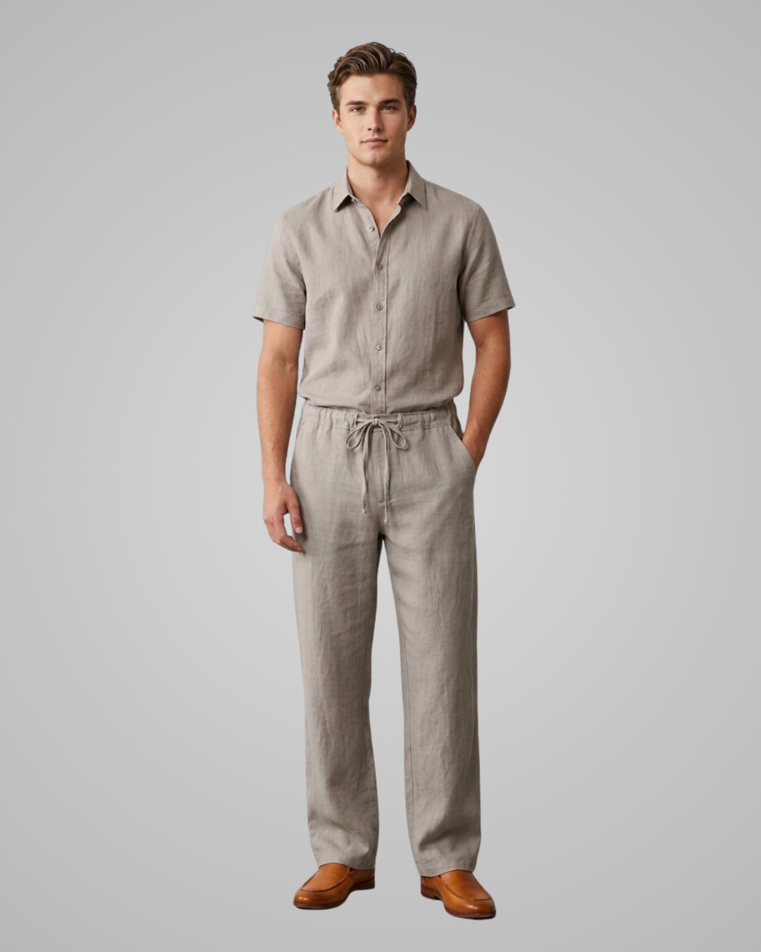 Man wearing a beige shirt and pants with brown shoes on a gray background