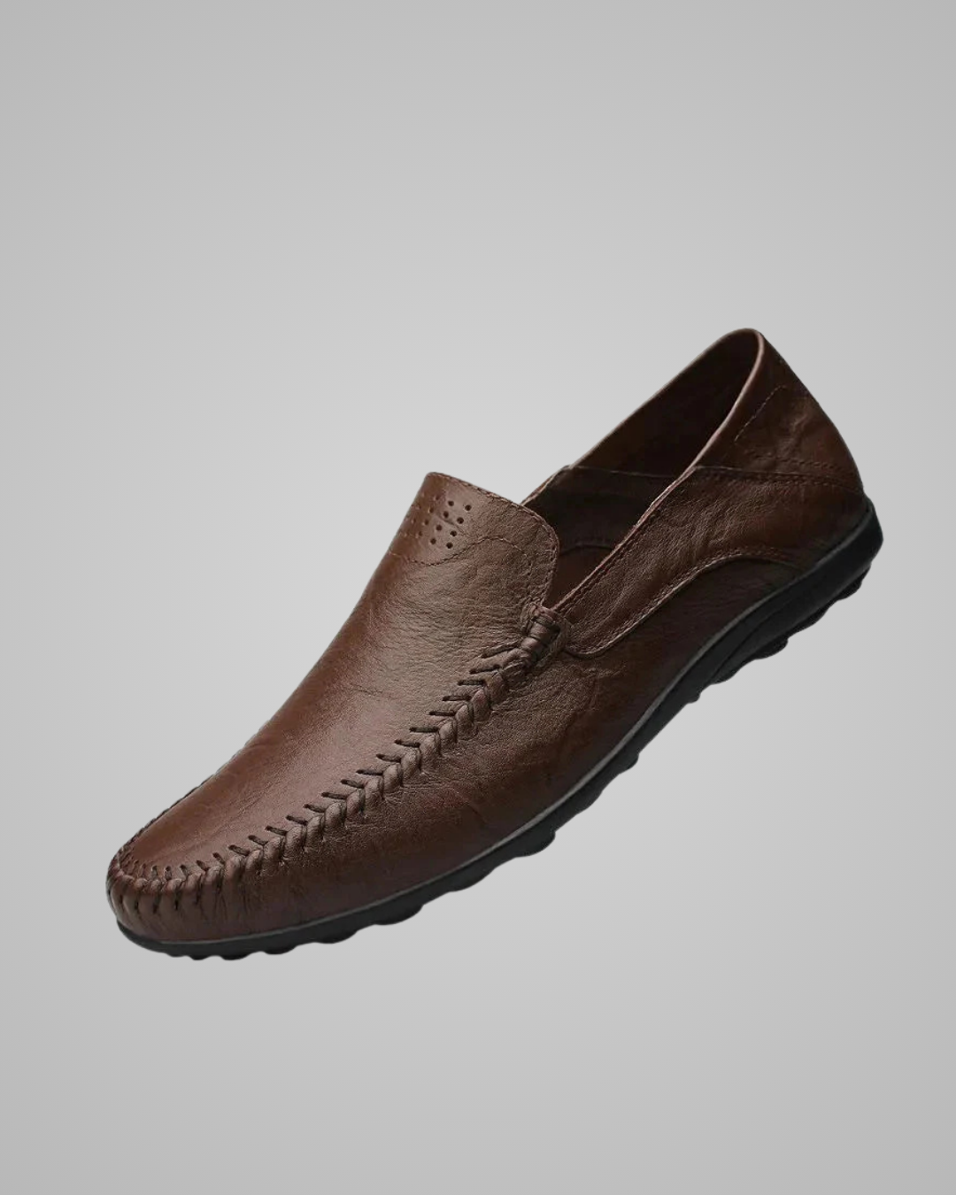 Brown leather loafer shoe on a gray background